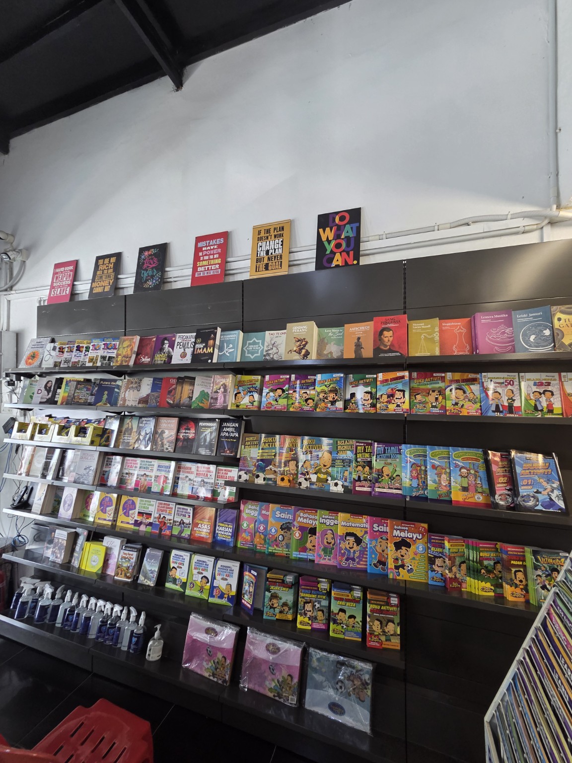 Books displayed on shelves at Prestasi Bookstore